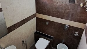 A bathroom with a sink, toilet, bidet, and shower. - Elis Hospitality Service Private Limited (Sanand)