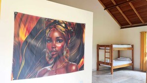 A room with a bunk bed, a large painting on the wall, and a tiled floor.