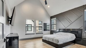 A bedroom with a bed, a ceiling fan, and a window with blinds. - Brand NEW Modern Stay Near Med Center, NRG, Downtown, & more (Houston)