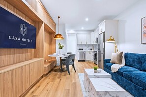 A modern kitchen with white cabinets, a marble countertop, and a built-in oven. - The Gerrard Brand New Riverdale Basement Suite (Toronto)