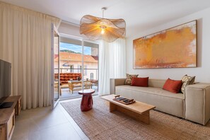Ein modernes Wohnzimmer mit einer Couch, einem Couchtisch und einem großen abstrakten Gemälde.