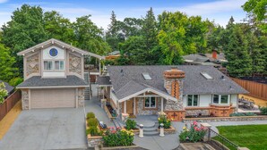 A two-story house with a garage, stone facade, and a landscaped front yard. - New Cozy 2-bedroom studio in Walnut Creek with AC (walnut creek)