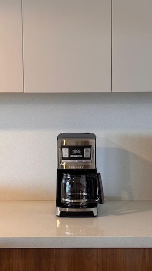 A coffee maker on a kitchen counter with a digital display. - Tropical luxury (Puerto Vallarta)