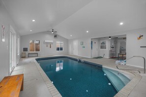 An indoor swimming pool with a wooden bench, ceiling fans, and a tiled floor. - 3BR Home, Indoor Pool, Hot Tub, Dog Friendly (Gulf Breeze)