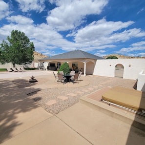A house with a patio, outdoor seating, and a view of the surrounding landscape. - Beautiful 4,000 sq ft home at the base of the Colorado National Monument. (Grand Junction)