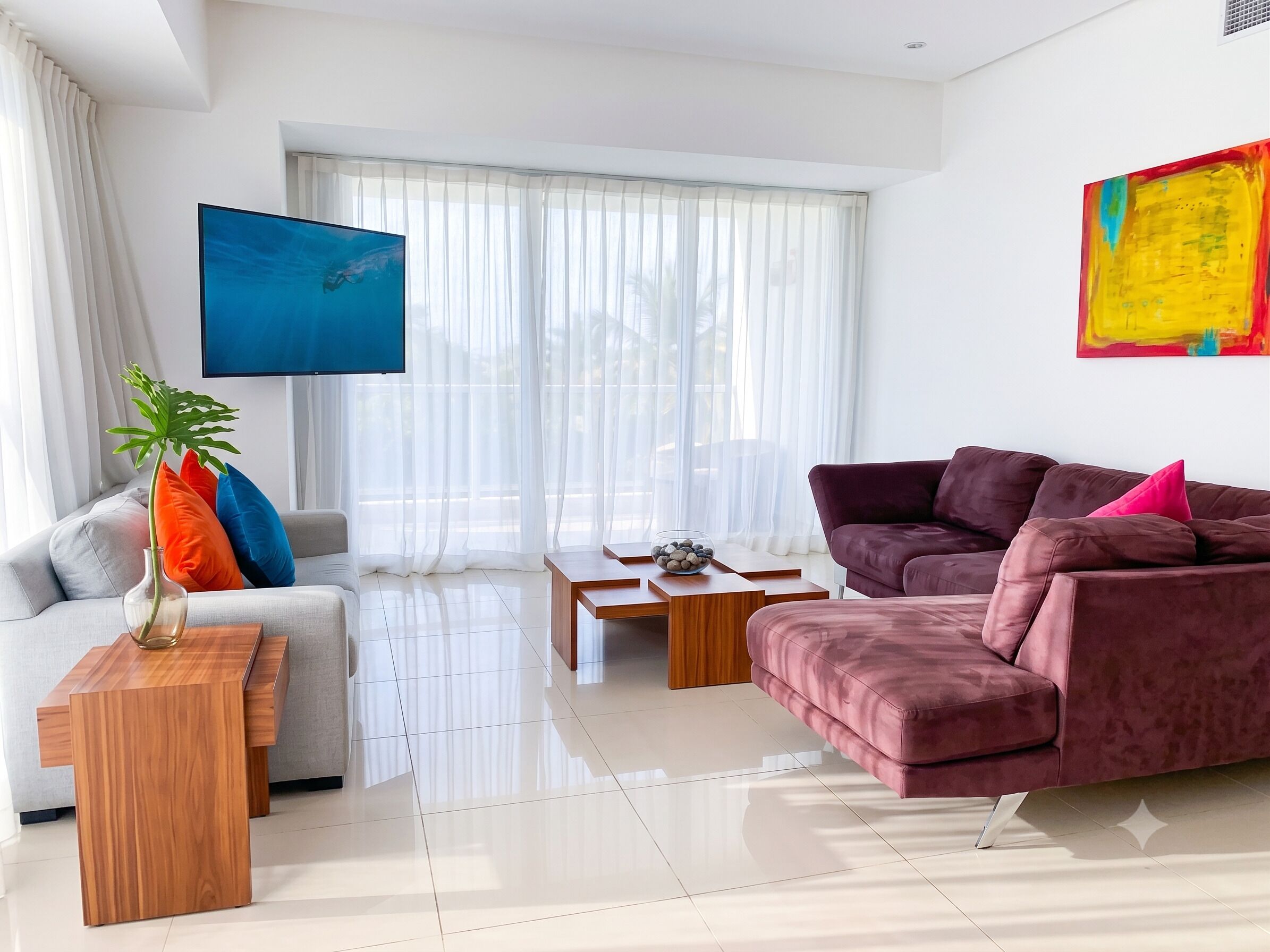 A modern living room with a sofa, a coffee table, and a TV.