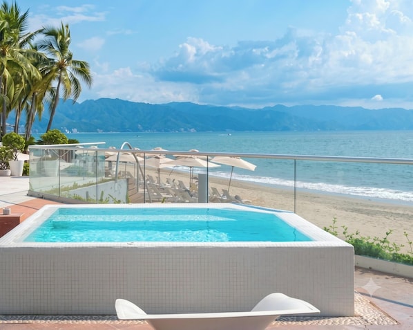 A pool with a view of the beach and mountains. - Icon Vallarta · 1BR Chic with Pool (Puerto Vallarta)