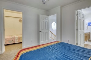 A bedroom with a bed, an open closet, and a door leading to a bathroom. - Peaceful Tahoe escape next to protected forest land, minutes from beaches, trails, and adventure (South Lake Tahoe)