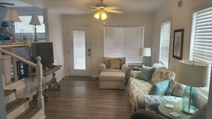 A living room with a sofa, armchair, and a ceiling fan. - 2 Bedroom home with Golf Cart! (Panama City Beach)