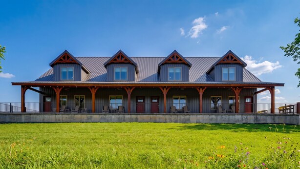A large building with multiple windows and a covered porch.