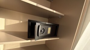 A wall-mounted safe with a keypad, a beige wall, and a white shelf. - 406 Tara-jre Jabal Al Lweibdeh With Stunning View (Amman)