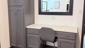 Une pièce comprenant un bureau, une chaise et une armoire.