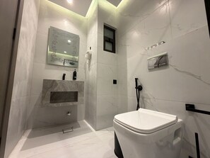 A modern bathroom with a toilet, a sink, and a shower area. - 408s Tara-jre Jabal Al Lweibdeh With Stunning View (Amman)