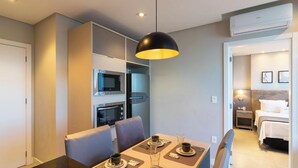 A modern hotel room with a dining area, kitchenette, and a separate bedroom. - House in Condo. w/ Garage in Salvador Tstedf0401 (Salvador)