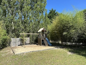A playground with a slide and climbing structure, surrounded by trees and a sandy area. - BOIS FLOTTE - VIELLE SAINT GIRONS (VIELLE SAINT GIRONS)