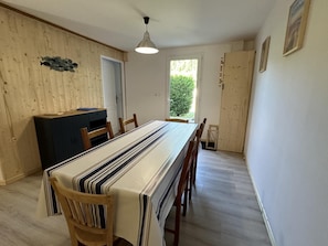 A dining area with a long table, chairs, a cabinet, and a door leading outside. - BOIS FLOTTE - VIELLE SAINT GIRONS (VIELLE SAINT GIRONS)