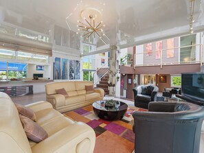 Ein geräumiger Wohnbereich mit Sofa, Couchtisch und Fernseher.