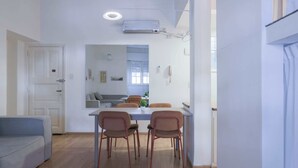 Un espace de vie moderne comprenant un coin repas, un canapé et une kitchenette.