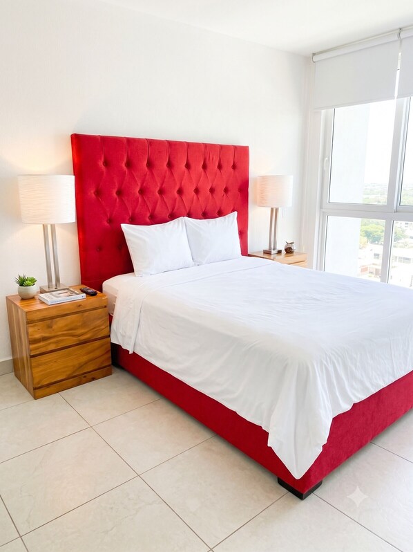 A bed with a red headboard, white bedding, and two bedside tables with lamps. - Gran Venetian Resort Stay Oceanfront by Monyxbnb (Puerto Vallarta)