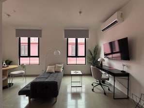 A modern room with a bed, desk, chair, TV, and large windows. - CASA KORSI, located in an area designated as a World Heritage Site! (Panamá)