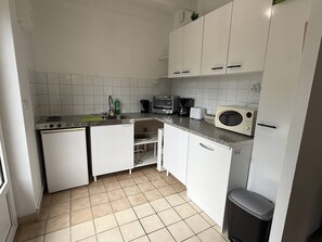 A compact kitchen with white cabinets, a microwave, a toaster, and a sink. - NEW LISTING, Domaine de KER-PAULT, between St Cast and Matignon, apartment 5 minutes from the... (MATIGNON)