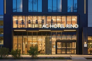 A hotel with a modern facade, large glass windows, and a prominent sign reading 'AC HOTEL RINO'. - AC Hotel Denver RiNo (Denver)