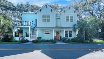 A two-story house with a front porch, a staircase, and a garage.