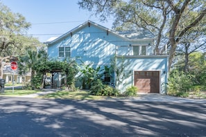 A two-story house with a garage, a porch, and a stop sign. - 3 Bedroom unit in American Beach,
Fernandina 
5 minutes walk away from the beach (Fernandina Beach)