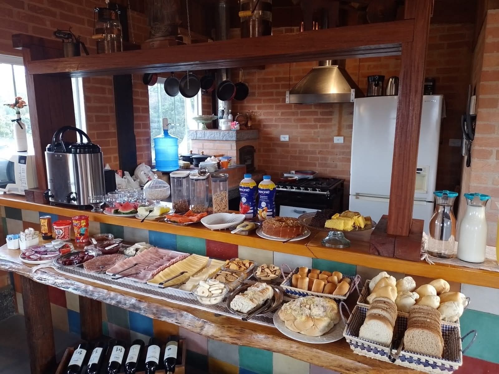 A buffet with various food items, a coffee machine, and a water dispenser.