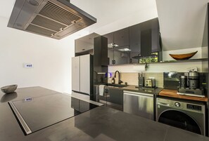A modern kitchen with a built-in dishwasher, a coffee machine, and a microwave. - Chic LA Guest House with Fire Pit & Private Patio (Los Angeles)