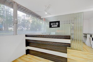 A reception desk with a sign reading 'HOTEL' and 'OYO-Serviced.' - Classic S Grand Residency (Hyderabad)