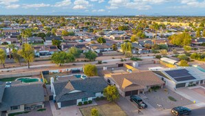 A residential area with houses, streets, and a clear sky. - 3bd, Pool, Hot Tub, Garage, Full Kitchen, ASU (Tempe)