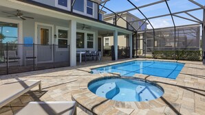 A residential property with a swimming pool, outdoor seating, and a covered patio area. - 7BR / 6BA w/ Private Pool / Solara Resort SO9051 (Kissimmee)