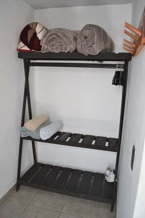 A bunk bed with storage shelves, a small shelf, and a heater. - Renovated 5 Element house with small pool 15 minutes from downtown Oaxaca (Oaxaca de Juárez)