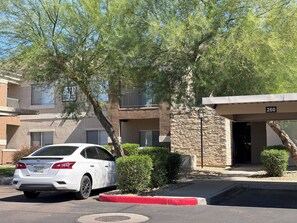 A white car parked in front of a building with a stone facade and a balcony. - Cozy 2-bedroom apartment with AC in soothing Glendale (Glendale)