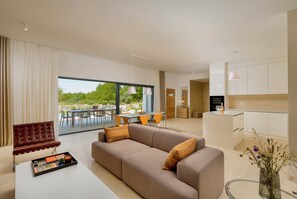 A modern living room with a sofa, dining area, and kitchen. - Villa Uno (Istria - Žminj) (Rovinj)