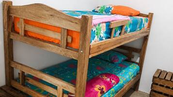 A bunk bed with colorful bedding and wooden headboard.