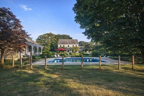 A house with a swimming pool, surrounded by a fenced yard and trees. - Great for group events, pool parties, and chefs looking to cook for large groups. (Eliot)
