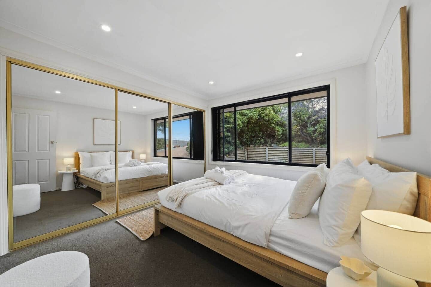 Spacious master bedroom featuring a comfortable bed and peaceful surroundings.