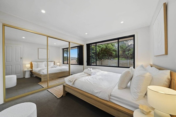Spacious master bedroom featuring a comfortable bed and peaceful surroundings.