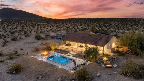 A desert house with a swimming pool, patio, and mountain view. - Sunflower - 40 Acres, Pool, Pickleball, Game Room! (Joshua Tree)