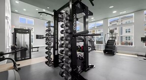 A gym with weightlifting equipment, benches, and cardio machines. - 2 King Beds | Pool, Gym & Easy First-Floor Access (Mooresville)