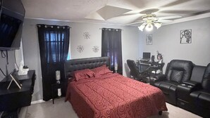 A bedroom with a bed, a desk, a chair, a TV, and a ceiling fan. - 2-bedroom townhome in terrific Attleboro  close to Gillette and Foxwoods (Attleboro)