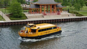 A yellow boat with 'CHICAGO WATERTAXI' written on the side, moving on a river. - Townhome 3 bedroom 2 bath with Parking - near McCormick Place , Chinatown Sox (Chicago)