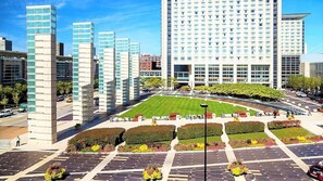 A modern hotel complex with multiple high-rise buildings, a central courtyard with a lawn, and a parking area. - Townhome 3 bedroom 2 bath with Parking - near McCormick Place , Chinatown Sox (Chicago)