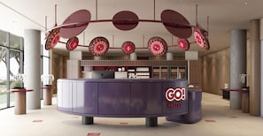 A modern hotel reception desk with a circular design, a 'GO! HOTEL' sign, and a large window in the background. - Go Hotel Chiang Rai (Chiang Rai)