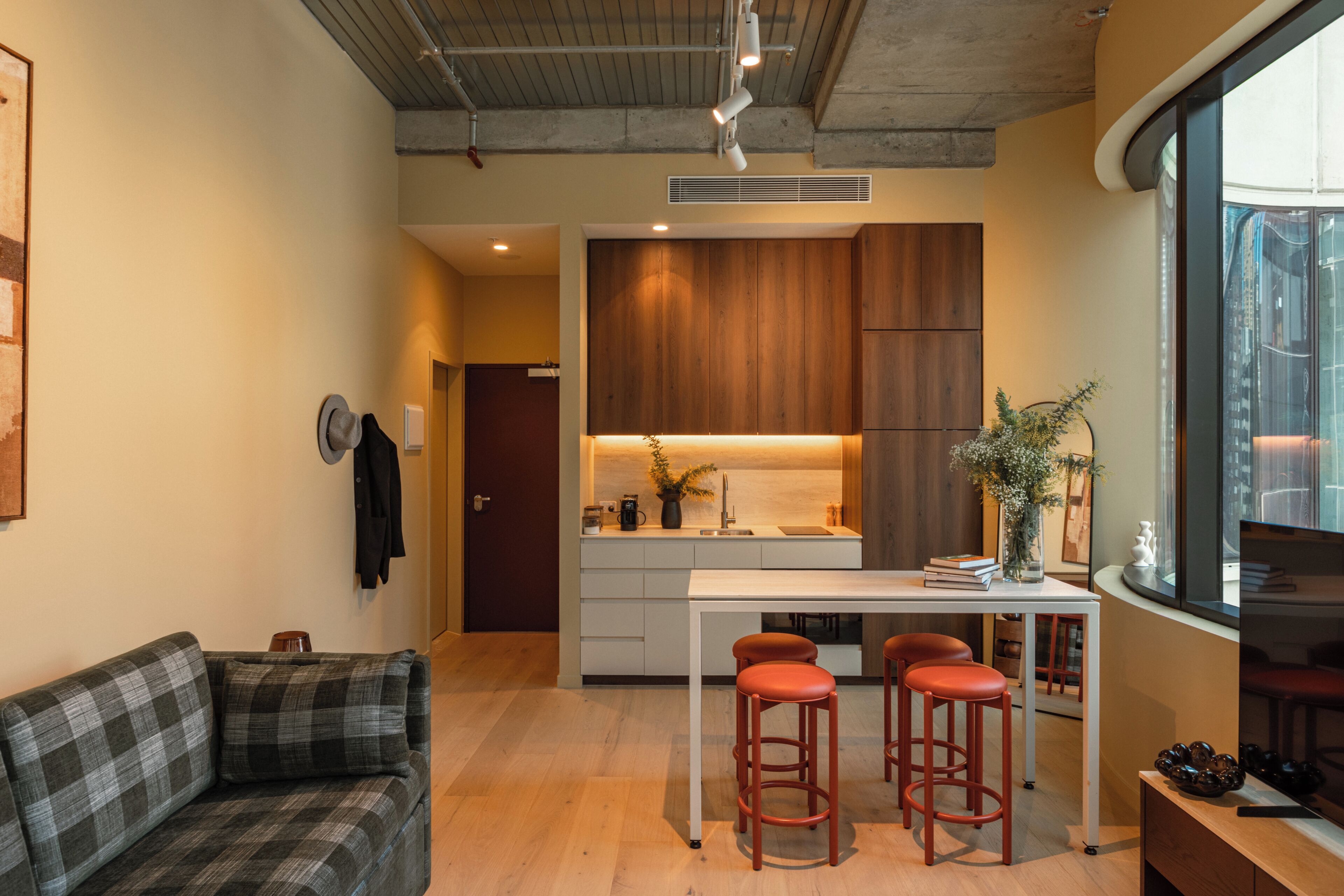 A modern interior with a kitchen, dining area, and seating.