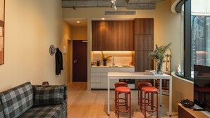 A modern interior with a kitchen, dining area, and seating. - The Lane House (Melbourne)