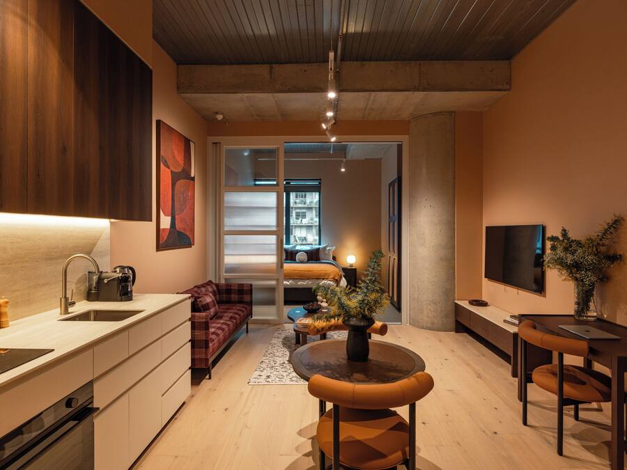 A modern interior with a kitchen, dining area, and living space.