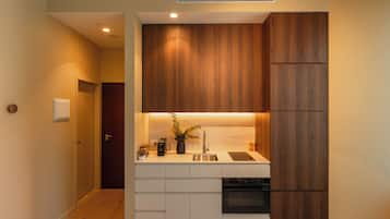 A compact kitchen with wooden cabinets, a built-in sink, and a stove.